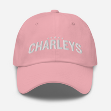 Load image into Gallery viewer, Classic dad hat with light pink fabric and white thread that says &quot;Charleys&quot; with five white stars.
