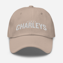 Load image into Gallery viewer, Classic dad hat with light tan fabric and white thread that says &quot;Charleys&quot; with five white stars.
